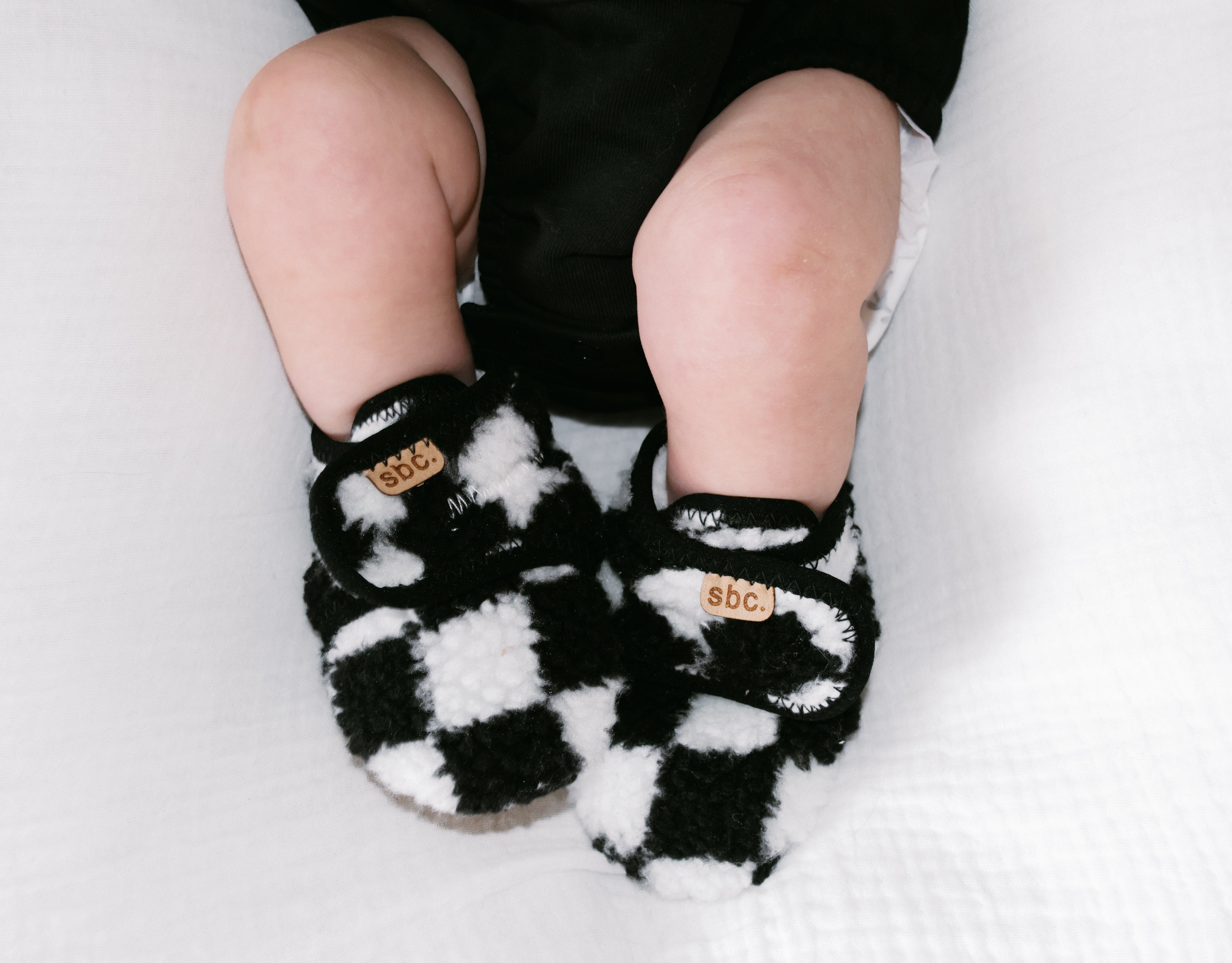 The Newborn Sherpa Bootie — Black + White Checkered